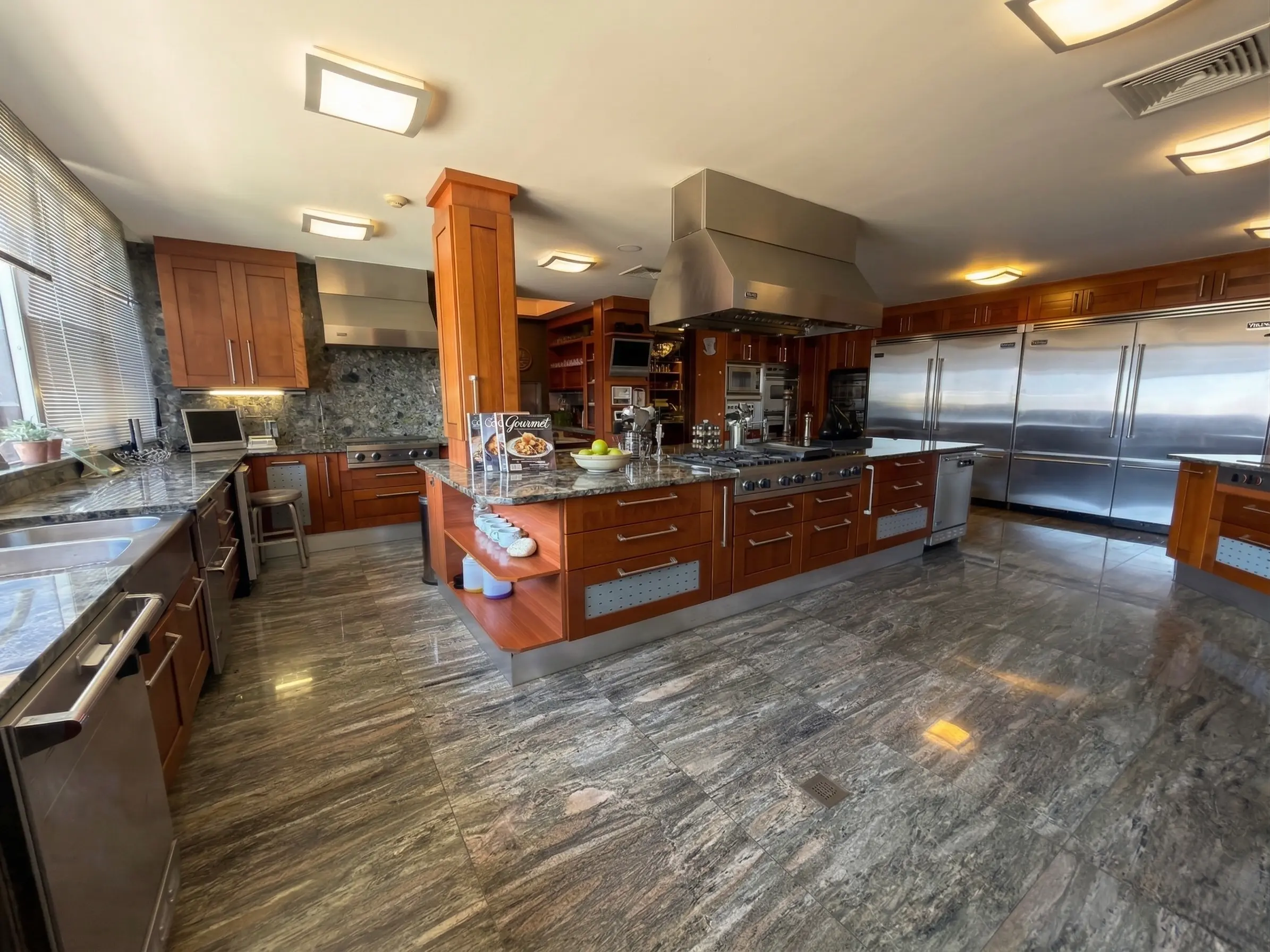 Full kitchen overview with cherry wood cabinets and professional Viking appliances