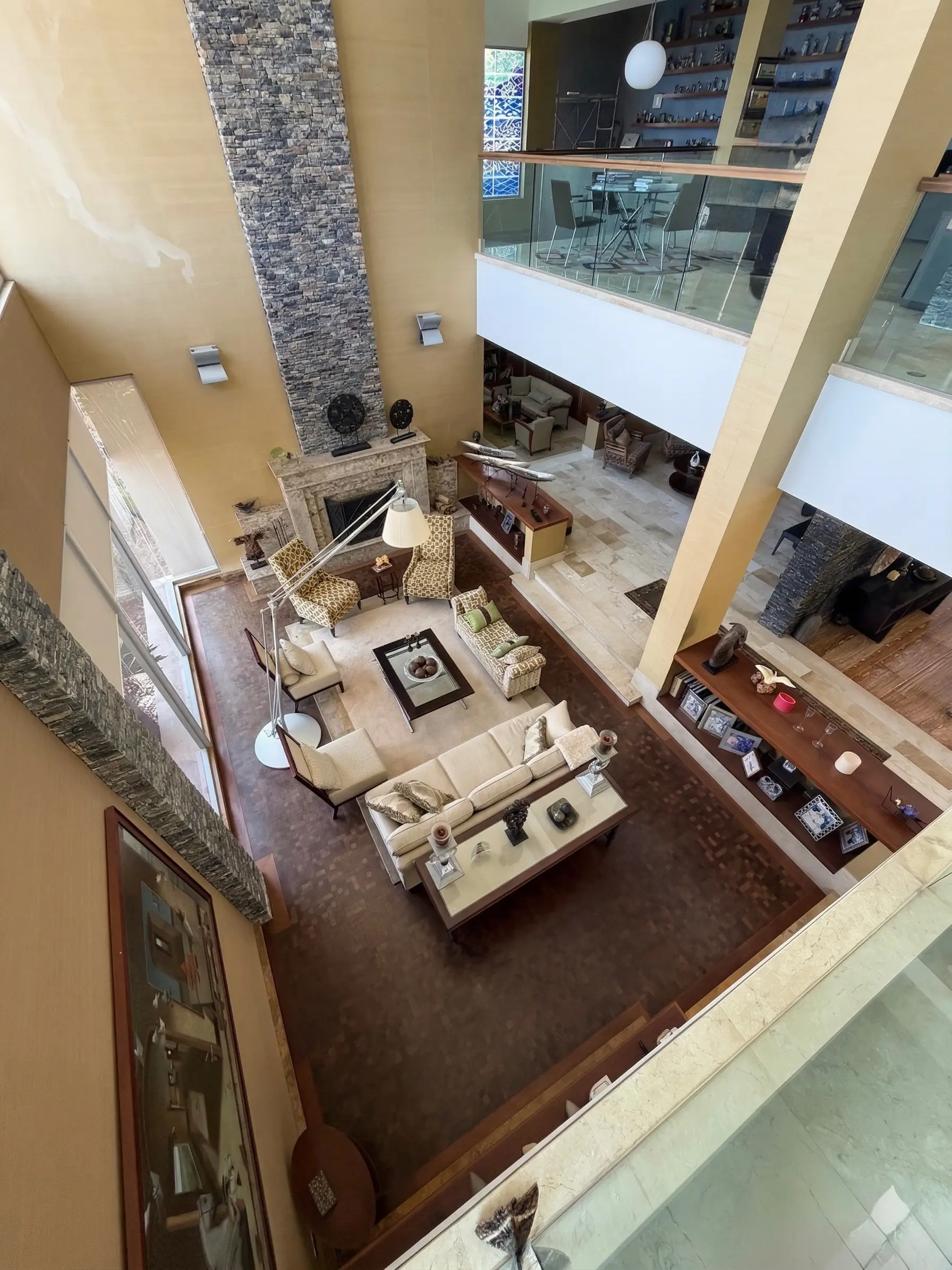 Grand double-height living room aerial view with panoramic mezzanine, ultra-luxury estate La Trinidad Caracas