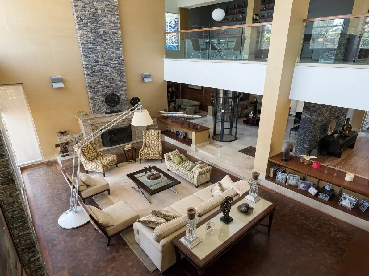 Grand double-height living room with stone fireplace and curated art collection, ultra-luxury estate Caracas